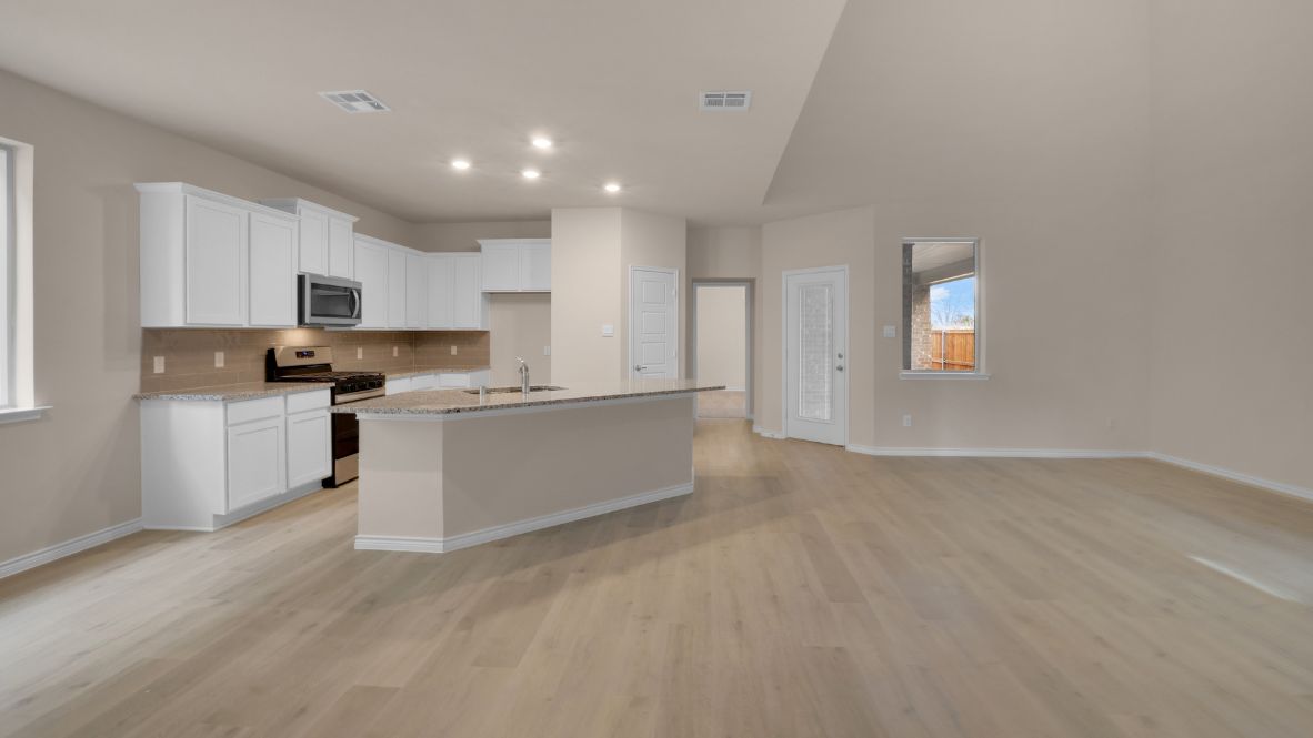 The home transitions into an open-concept layout featuring the corner kitchen layout, nook, and family room. The kitchen is a true centerpiece, equipped with a large center island, plenty of counter space, and modern appliances. With ample cabinetry and a convenient pantry, it’s designed to make both meal prep and storage a breeze. The nook sits adjacent to the kitchen, offering a cozy dining space for family meals or casual gatherings. To your left is the powder room, perfectly placed for guests. Tucked away off the nook is a powder room, perfectly placed for guests.