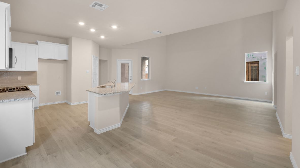 The home transitions into an open-concept layout featuring the corner kitchen layout, nook, and family room. The kitchen is a true centerpiece, equipped with a large center island, plenty of counter space, and modern appliances. With ample cabinetry and a convenient pantry, it’s designed to make both meal prep and storage a breeze. The nook sits adjacent to the kitchen, offering a cozy dining space for family meals or casual gatherings. To your left is the powder room, perfectly placed for guests. Tucked away off the nook is a powder room, perfectly placed for guests.