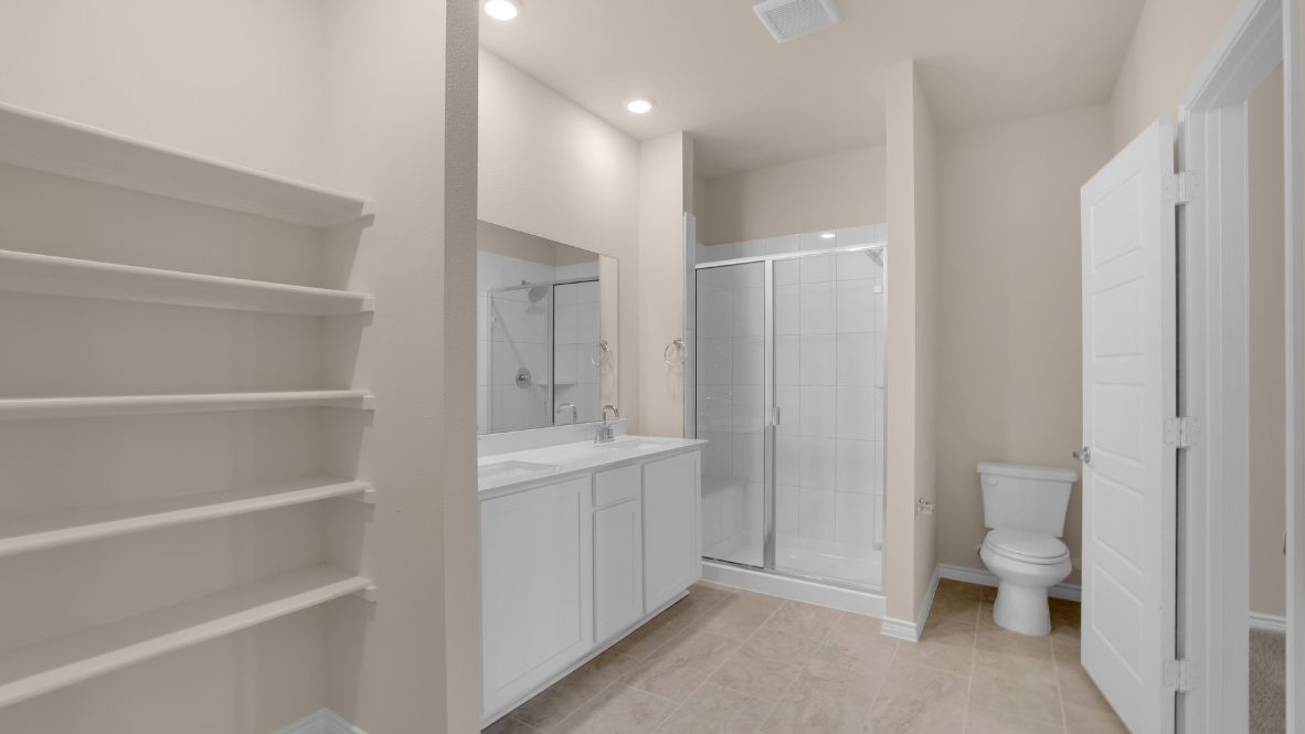 Tucked away from the main living areas is the owner’s suite, a private retreat on the first floor. This generously sized room offers a relaxing escape with a spa-like en suite bathroom that includes dual sinks, a walk-in shower, and an impressive walk-in closet.