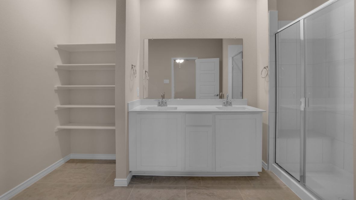 Tucked away from the main living areas is the owner’s suite, a private retreat on the first floor. This generously sized room offers a relaxing escape with a spa-like en suite bathroom that includes dual sinks, a walk-in shower, and an impressive walk-in closet.