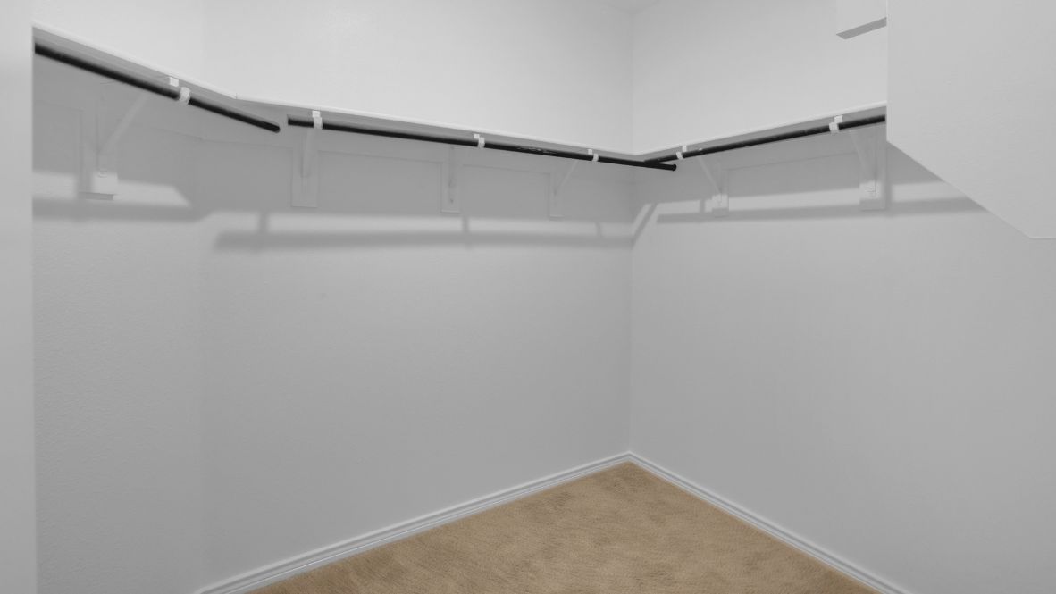 Tucked away from the main living areas is the owner’s suite, a private retreat on the first floor. This generously sized room offers a relaxing escape with a spa-like en suite bathroom that includes dual sinks, a walk-in shower, and an impressive walk-in closet.