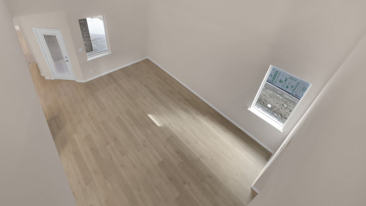 The second floor offers three additional bedrooms, including a full suite perfect for extended family or guests. An open-to-below hallway with stylish railings on either side provides a stunning view of the family room below.