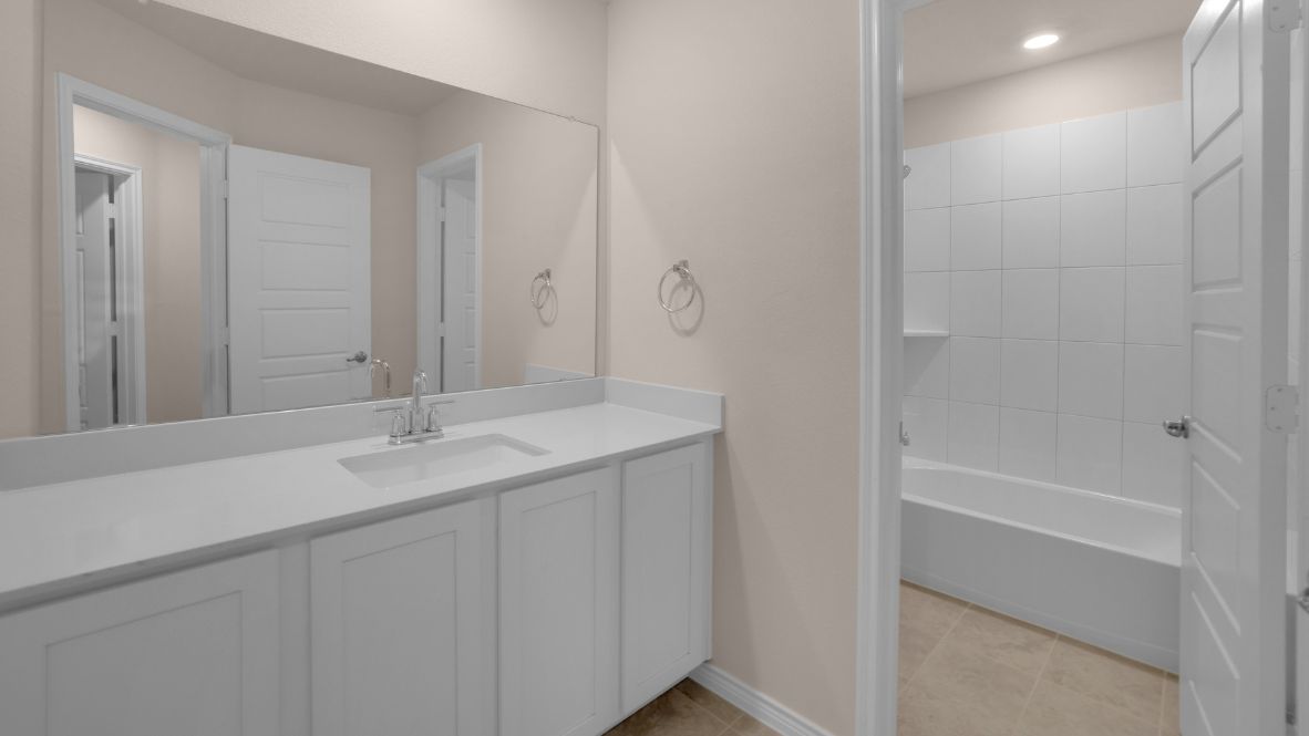 The second floor offers three additional bedrooms, including a full suite perfect for extended family or guests. An open-to-below hallway with stylish railings on either side provides a stunning view of the family room below.