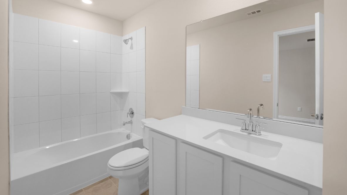 The second floor offers three additional bedrooms, including a full suite perfect for extended family or guests. An open-to-below hallway with stylish railings on either side provides a stunning view of the family room below.