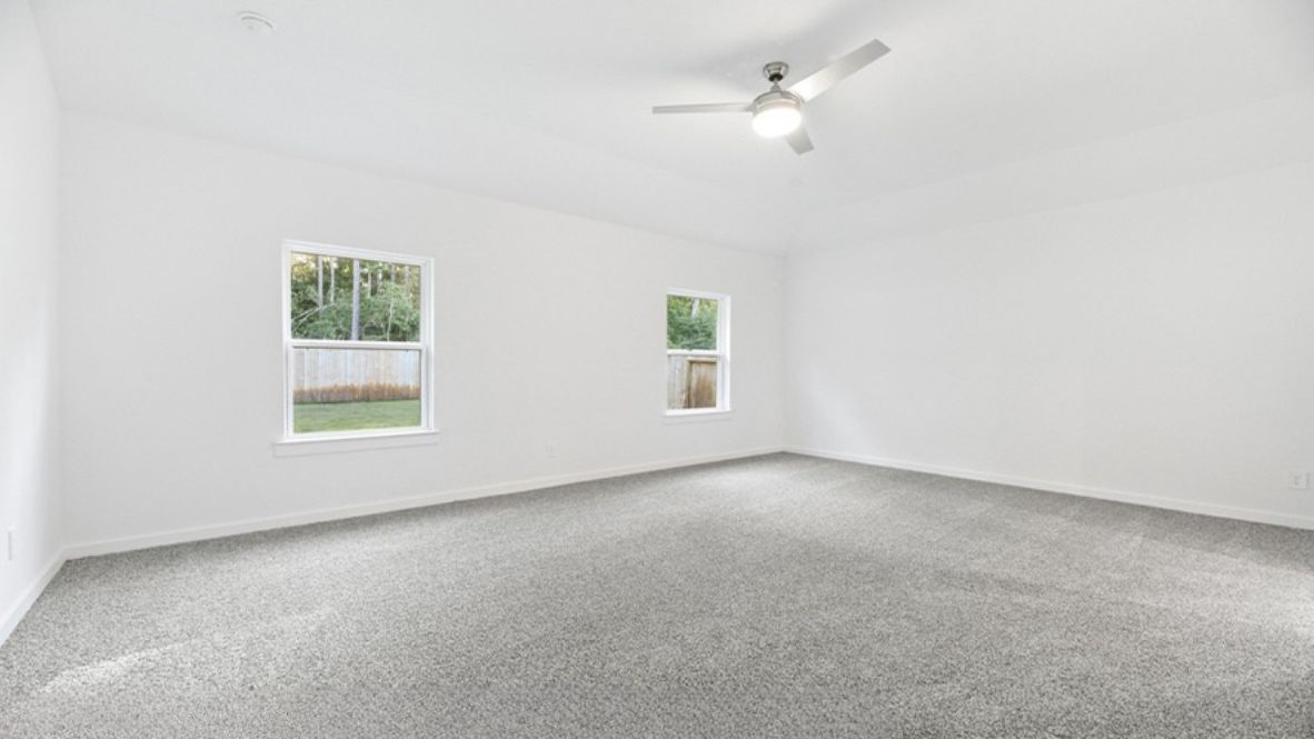 bedroom with large windows and plush carpet