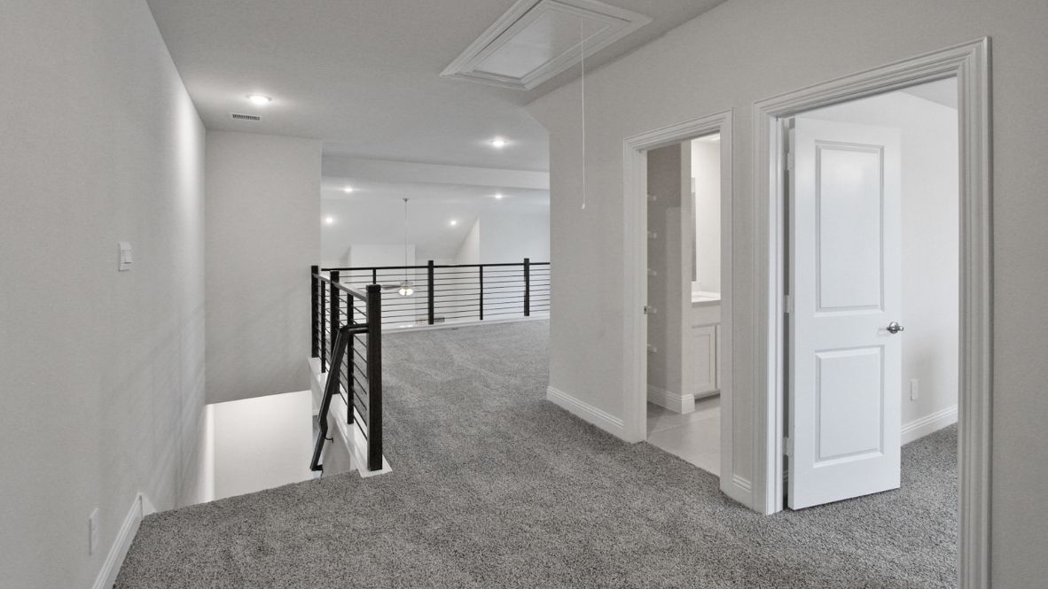 Comfortable guest bedroom featuring neutral-toned walls, carpeted flooring, and a large closet.
