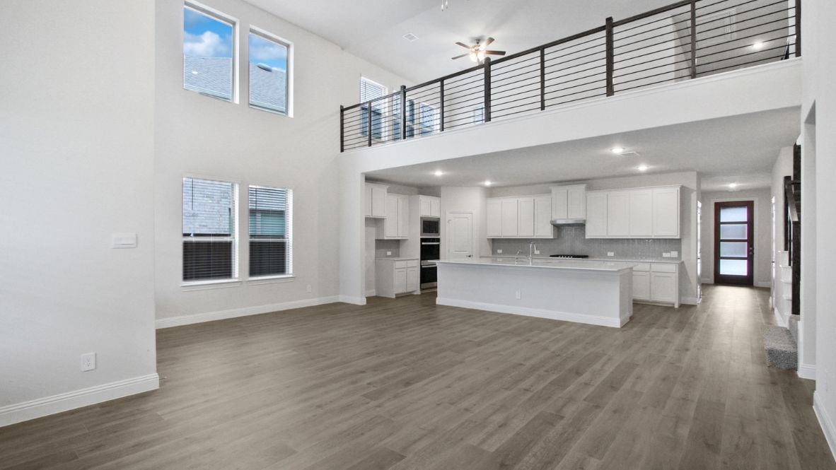 A well-organized living room that includes a kitchen and dining area, creating a warm and welcoming environment for gatherings.