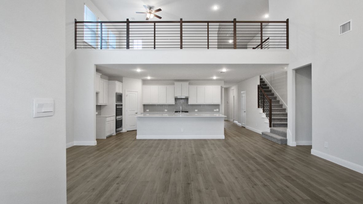 A well-organized living room that includes a kitchen and dining area, creating a warm and welcoming environment for gatherings.