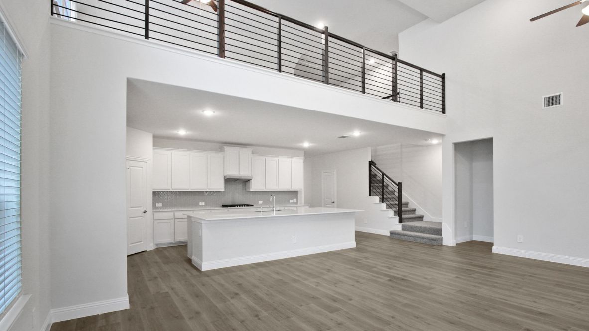 A well-organized living room that includes a kitchen and dining area, creating a warm and welcoming environment for gatherings.