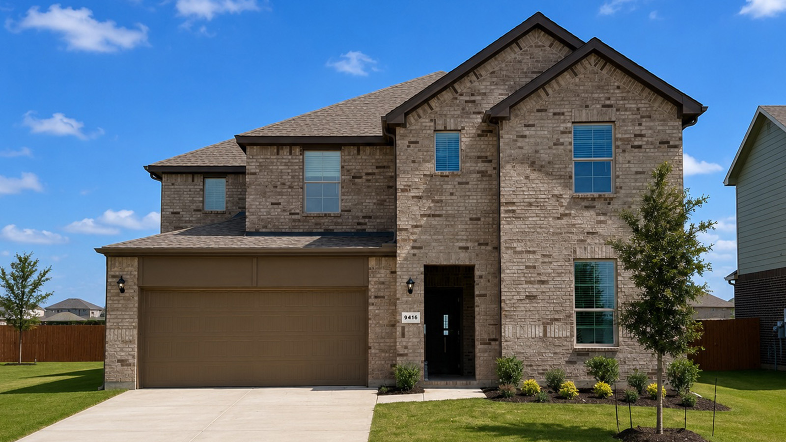 Exterior two-story brick house in Mckinney, Texas. Evergreen floor plan.