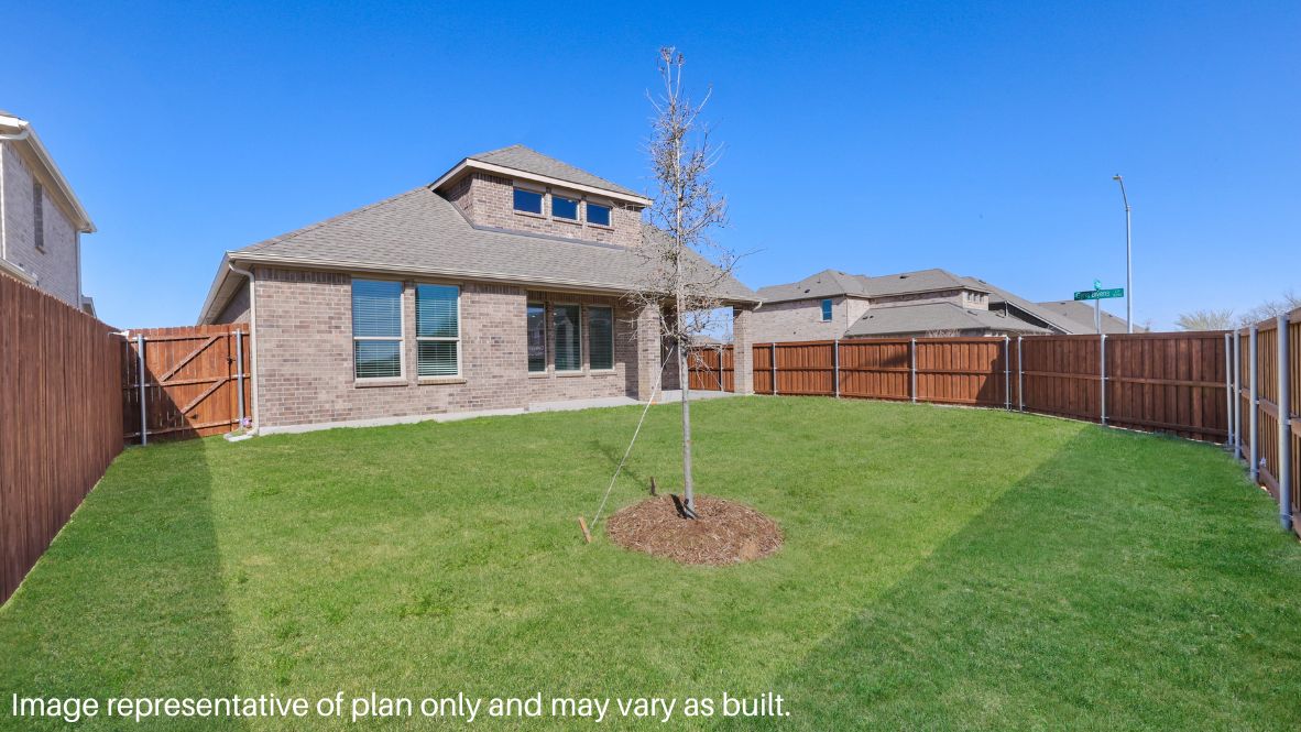 Just beyond, the covered patio is a peaceful retreat to unwind as the sun sets over the neighborhood.