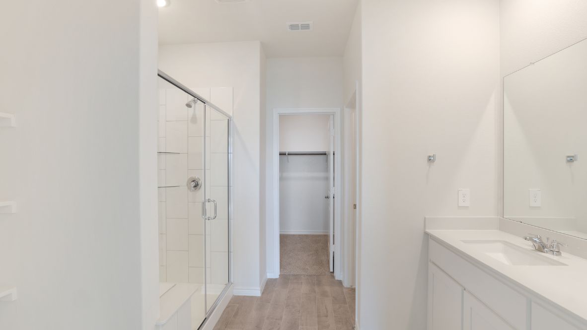 The primary suite, nestled on the main floor, offers a quiet sanctuary. With its walk-in closet and a spa-like ensuite bathroom featuring a double vanity and walk-in shower, perfect to unwinding after a long day.