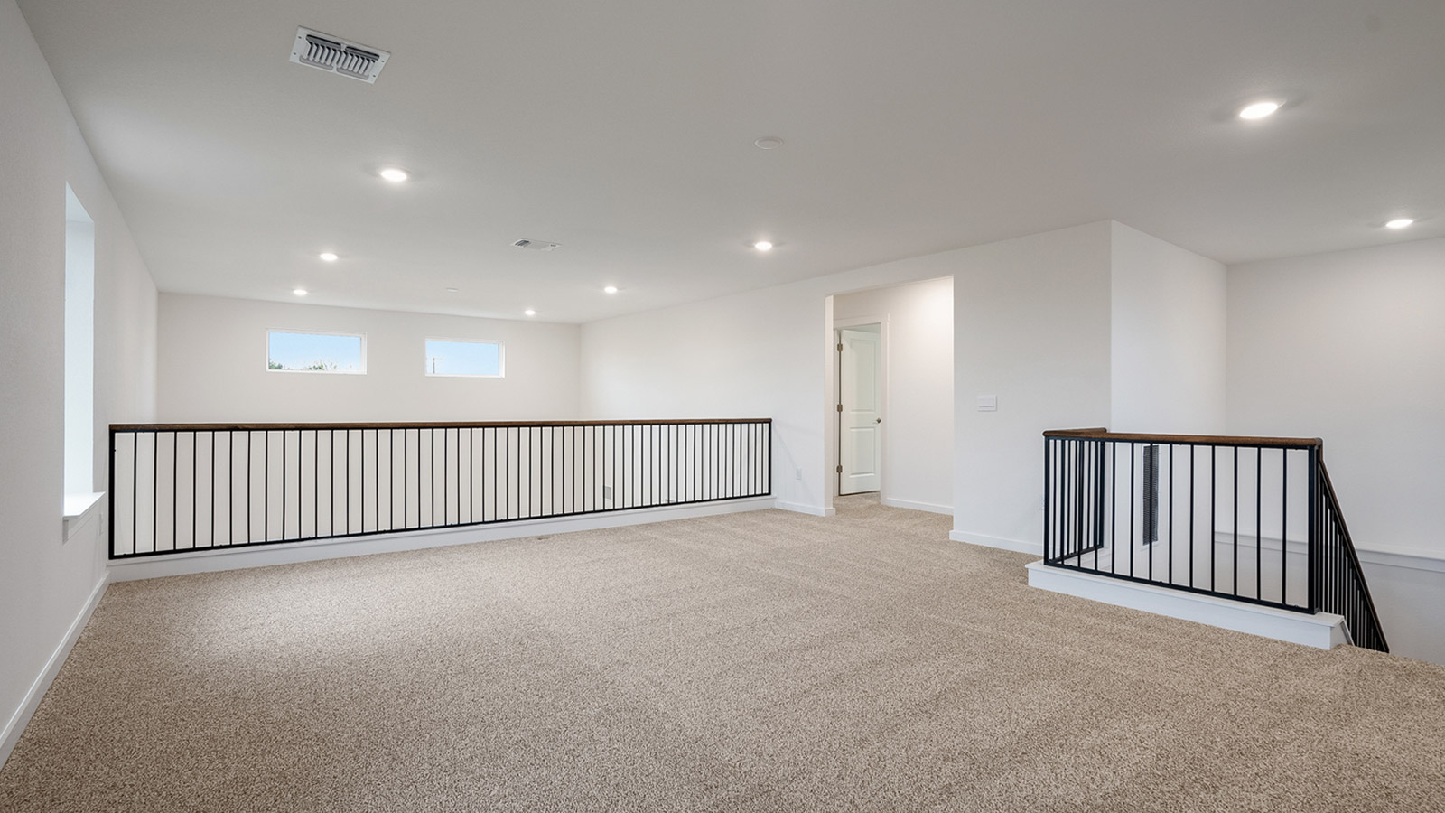 upstairs spacious game room with open to below view of first floor.