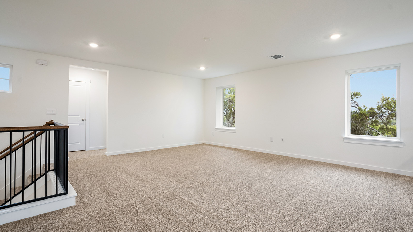 spacious upstairs entertsinment space with natural light