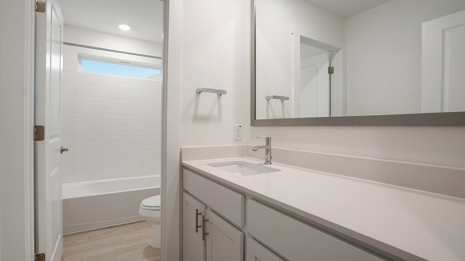 bathroom with glass shower door and bright white light