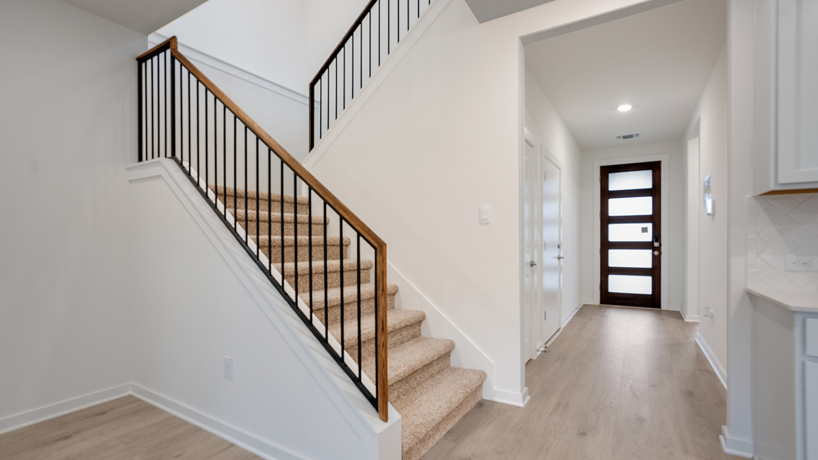 wooden staircase with metal railing
