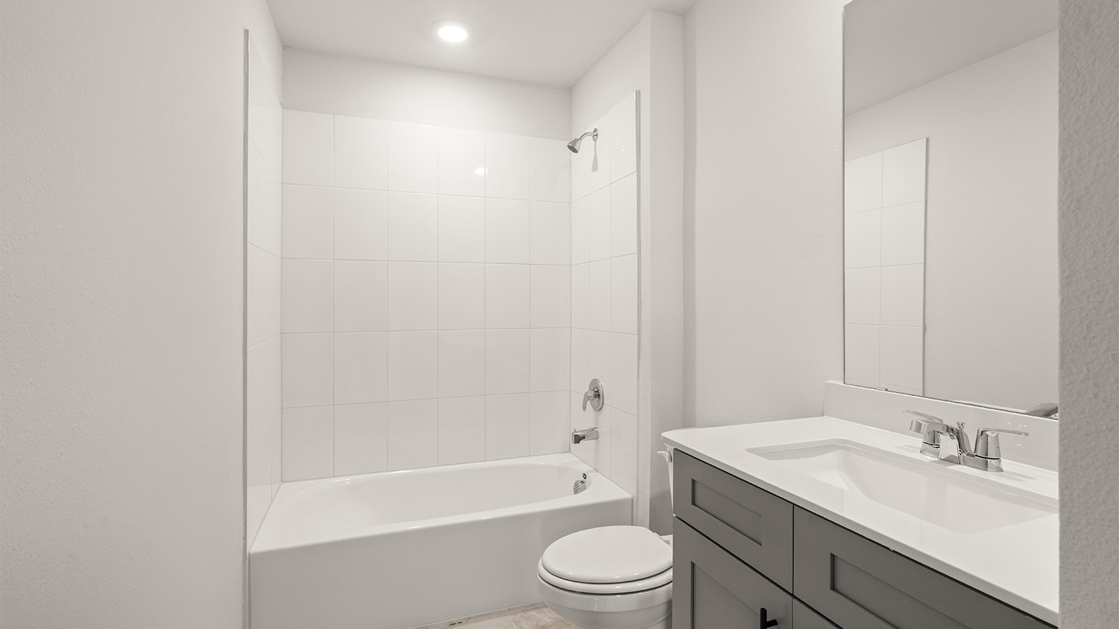 Modern primary bathroom with single vanities, granite countertops, and a enclosed shower