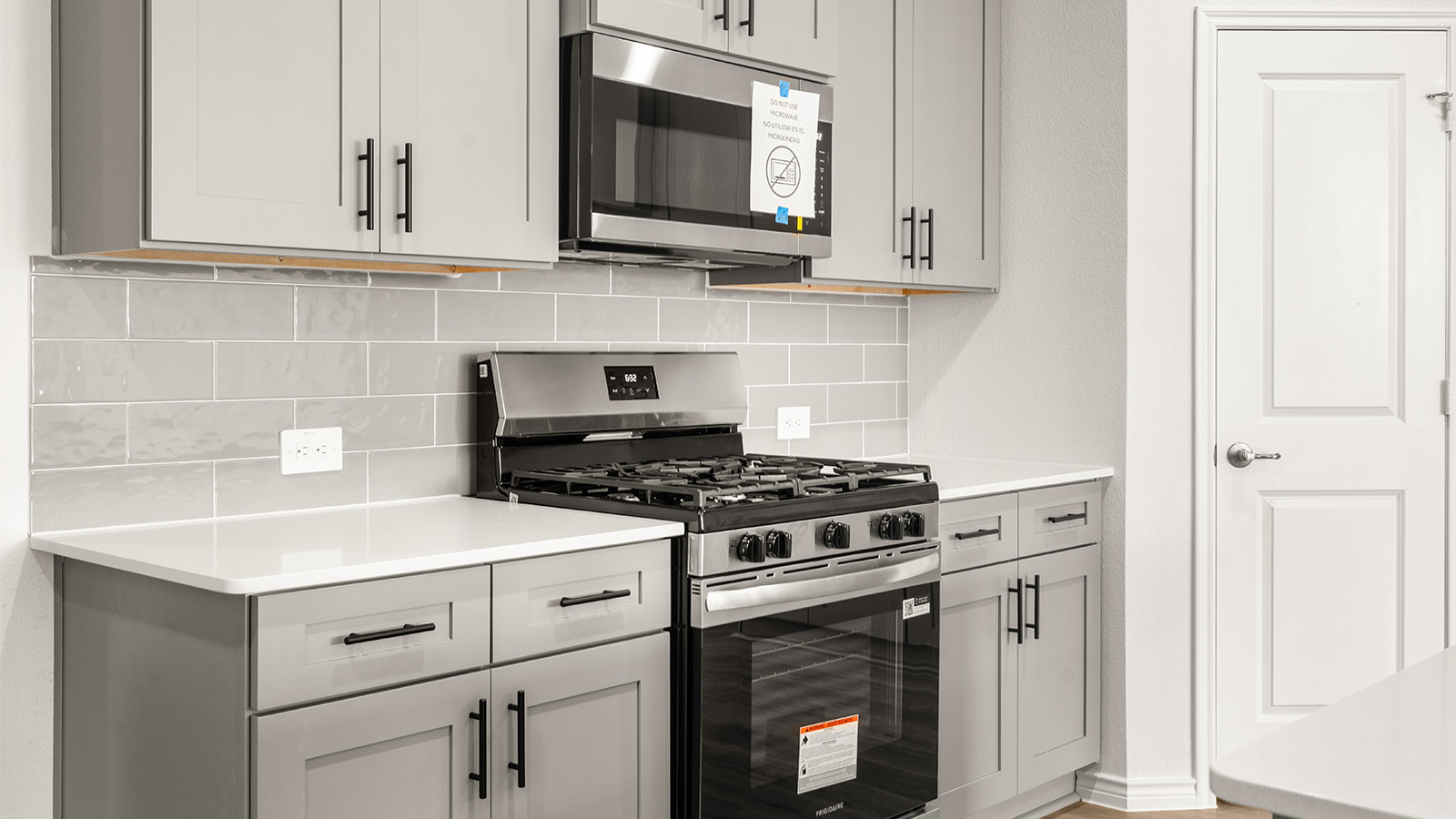 Bright and spacious kitchen with granite countertops, stainless steel appliances, and an island with bar seating.