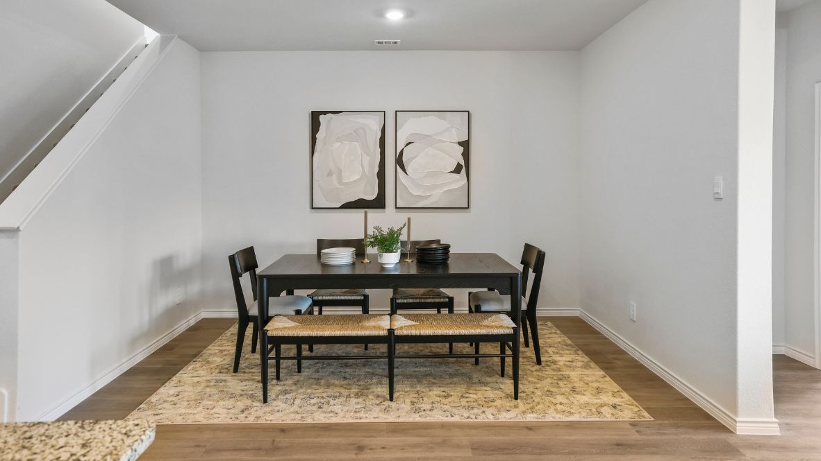 Spacious dining area with vinyl wood flooring.