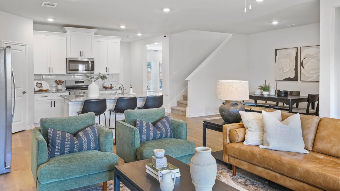 A cozy living room featuring a comfortable couch, a stylish coffee table, and an elegant painting on the wall.