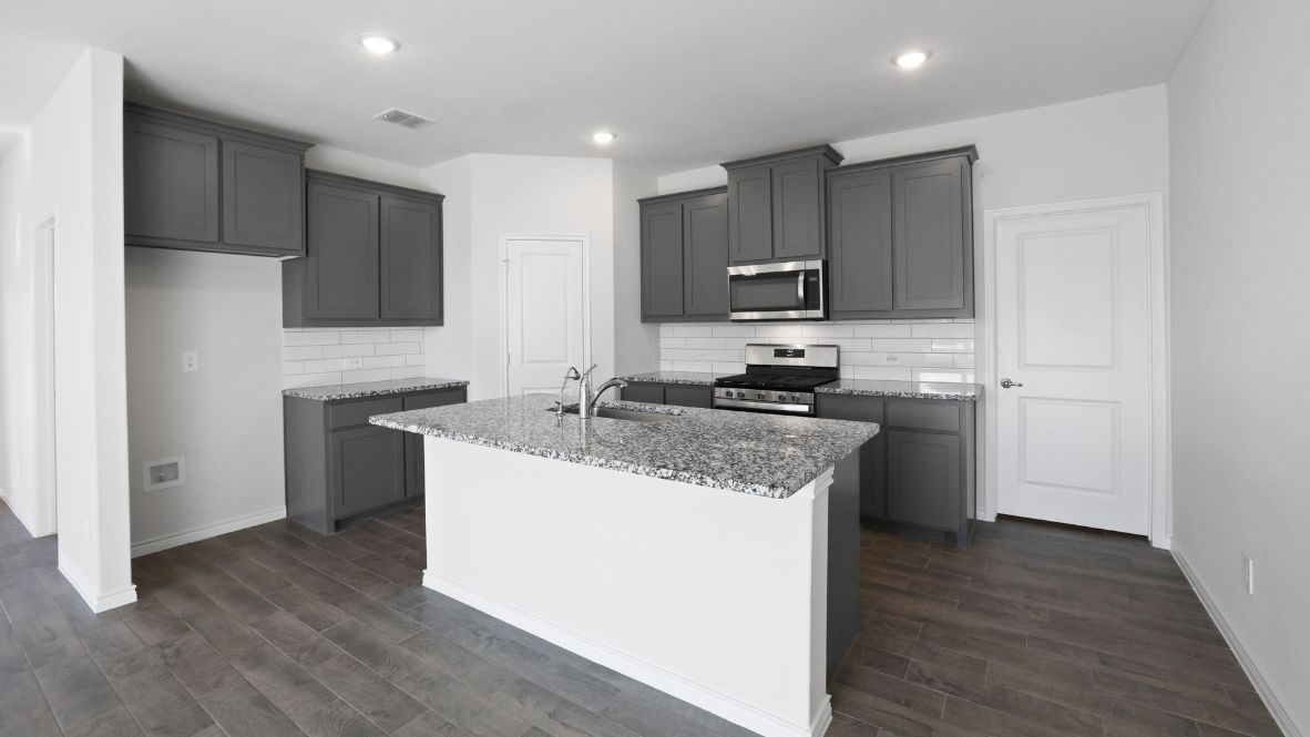 Modern kitchen with granite countertops.