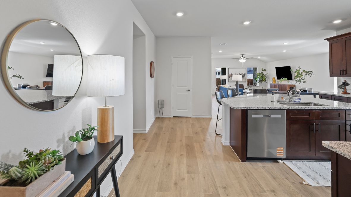 Bright and spacious kitchen with granite countertops, stainless steel appliances, and an island with bar seating.