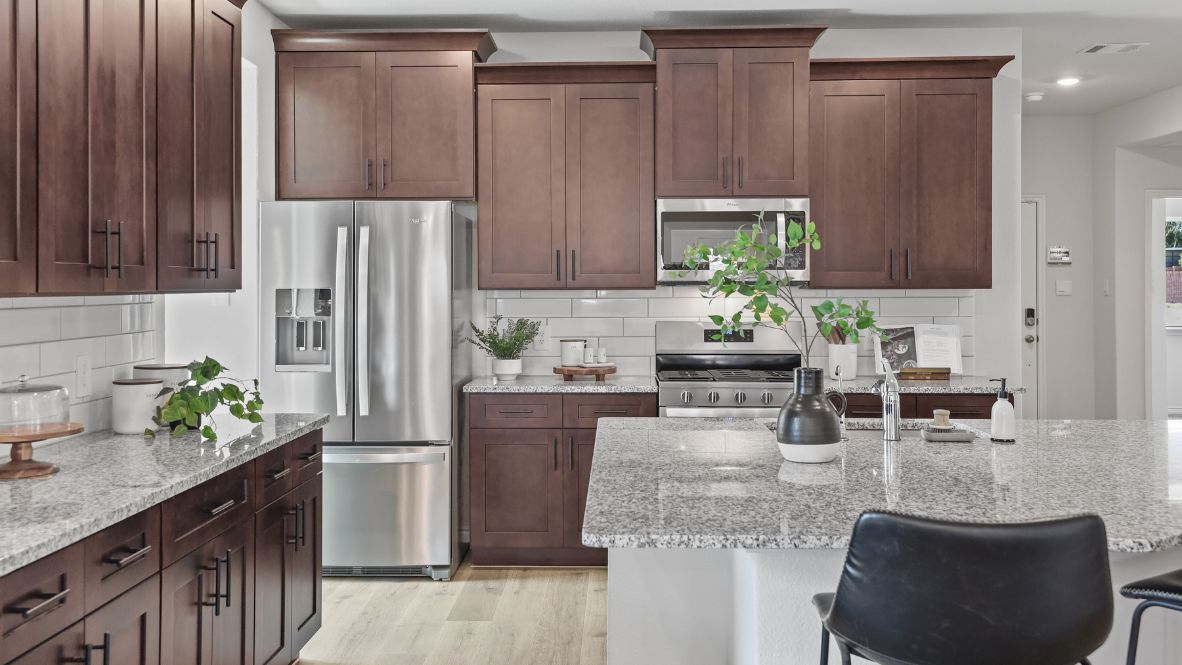 Spacious kitchen with wooden cabinets and granite countertops.