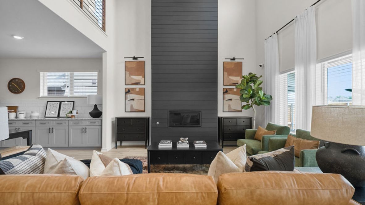 A well-organized living room that includes a kitchen and dining area, creating a warm and welcoming environment for gatherings.