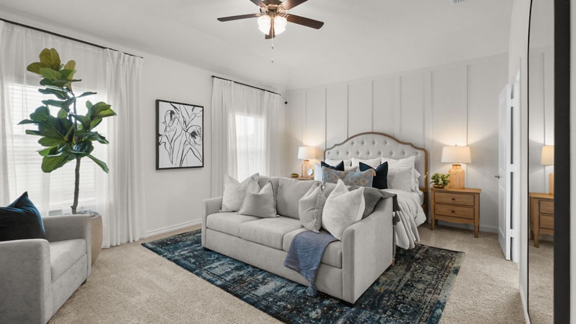 Guest bedroom with ceiling fan and bedroom windows.