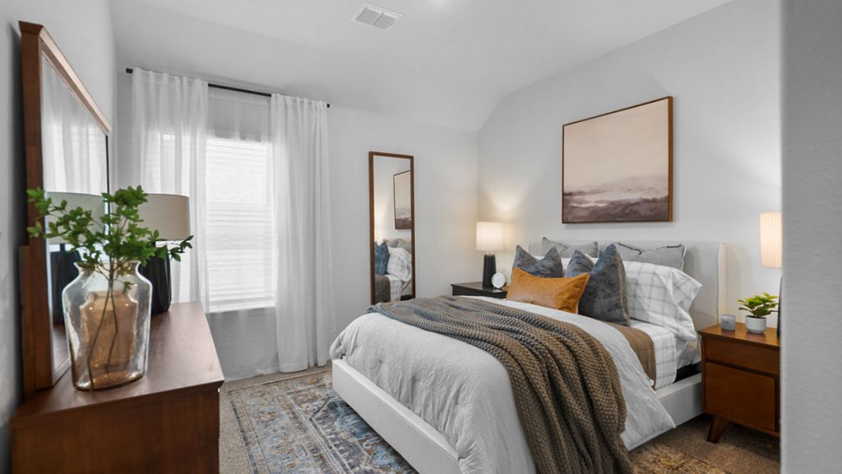 Comfortable guest bedroom featuring neutral-toned walls, carpeted flooring, and a nice window.