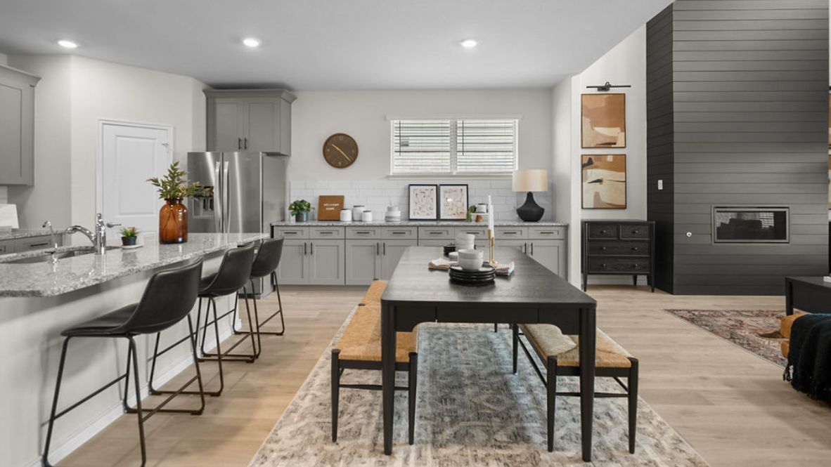 Bright and spacious kitchen with granite countertops, stainless steel appliances, and an island with bar seating.