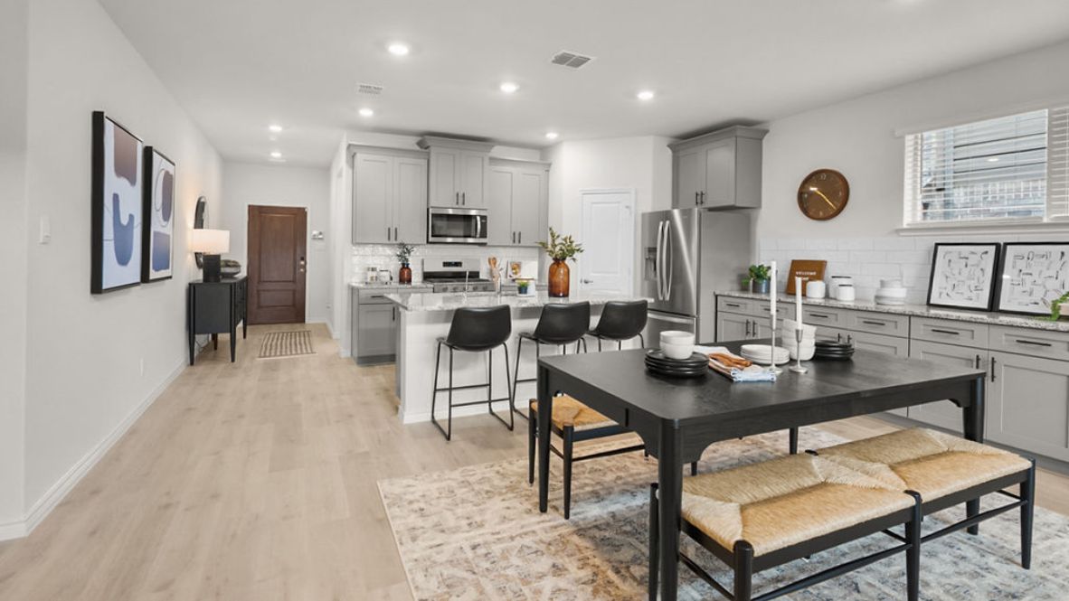 A well-organized living room that includes a kitchen and dining area, creating a warm and welcoming environment for gatherings.