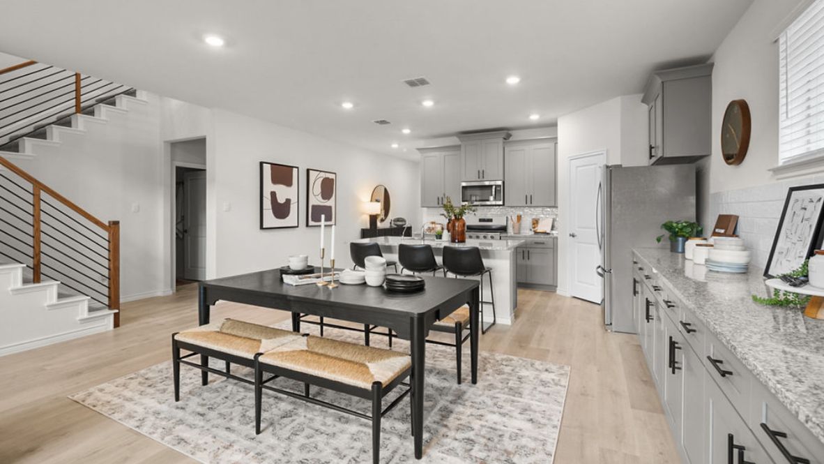 A well-organized living room that includes a kitchen and dining area, creating a warm and welcoming environment for gatherings.