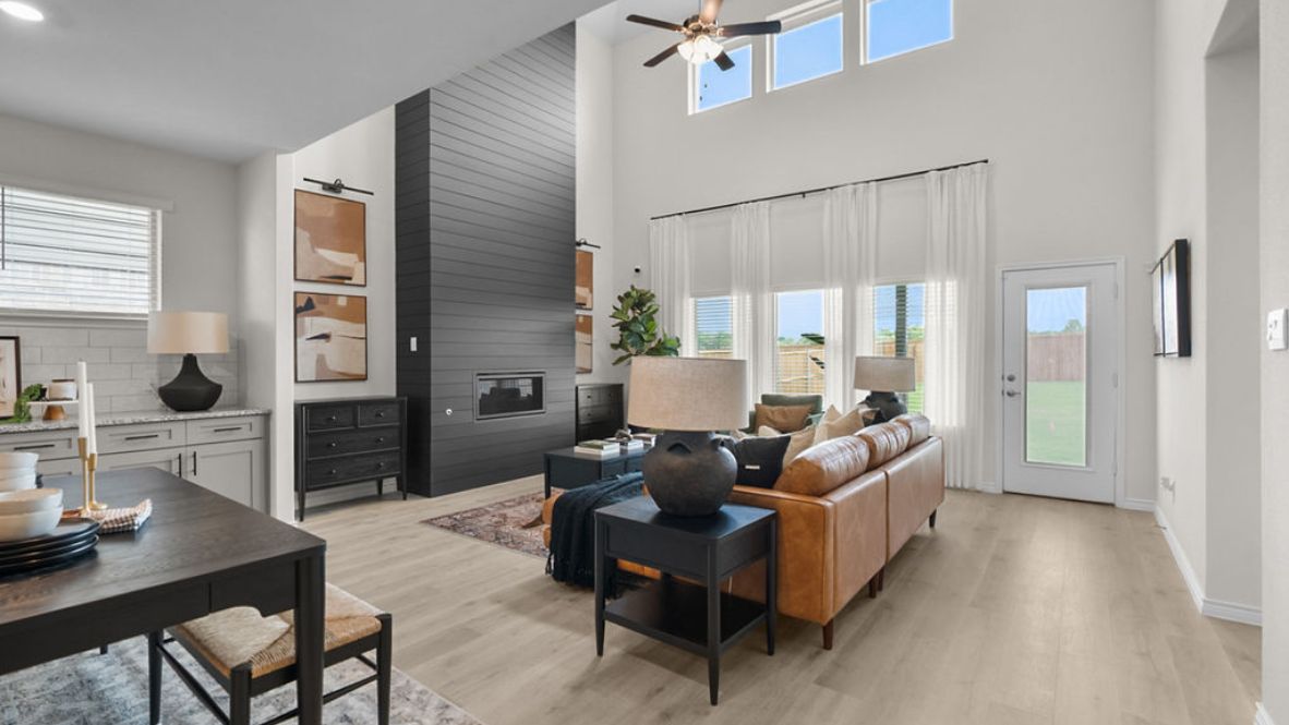 A well-organized living room that includes a kitchen and dining area, creating a warm and welcoming environment for gatherings.