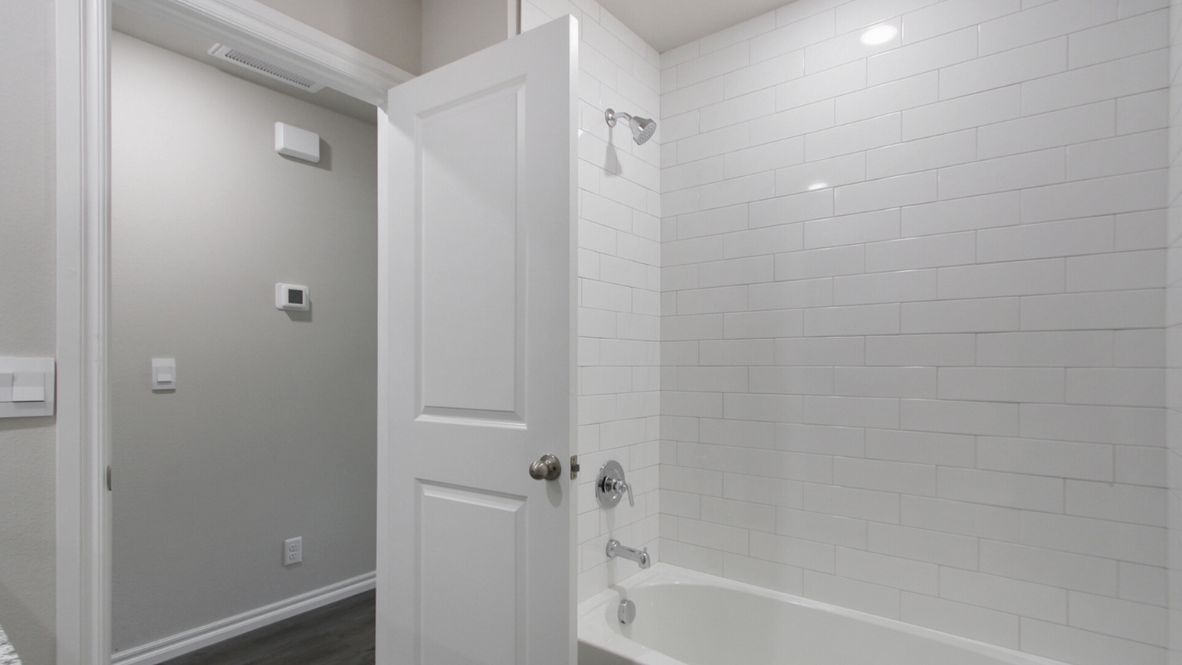 Welcome to the Denton floor plan, where modern charm meets cozy elegance in the heart of The Conrad Village Community, nestled in scenic Bixby, Oklahoma. This one-story haven offers 3 bedrooms, 2 baths, and a generous 1575 square feet of living space, perfect for those seeking a warm and inviting retreat.  From the outside, admire the traditional brick or brick and rock exterior, exuding timeless allure and modern curb appeal. Step inside to discover an open concept layout that effortlessly combines style and functionality. The kitchen features painted white shaker-style cabinets, granite countertops, and stainless steel appliances, creating a welcoming atmosphere that overlooks the dining area and living room, ideal for gatherings and entertaining.  As you explore further, you'll find comfort in every corner. Sink your feet into plush carpeting in the bedrooms, while the main living areas and halls boast durable luxury vinyl wood flooring, adding a touch of rustic charm to your everyday life. Indulge in the luxury of the primary suite, complete with a dual vanity, huge walk-in closet, separate water closet, and a large walk-in shower, ensuring your comfort and convenience.  Experience the convenience of smart home features included in every Denton floor plan. Schedule a tour today and discover your perfect blend of modern luxury and cozy warmth at The Conrad Village Community in Bixby, Oklahoma.