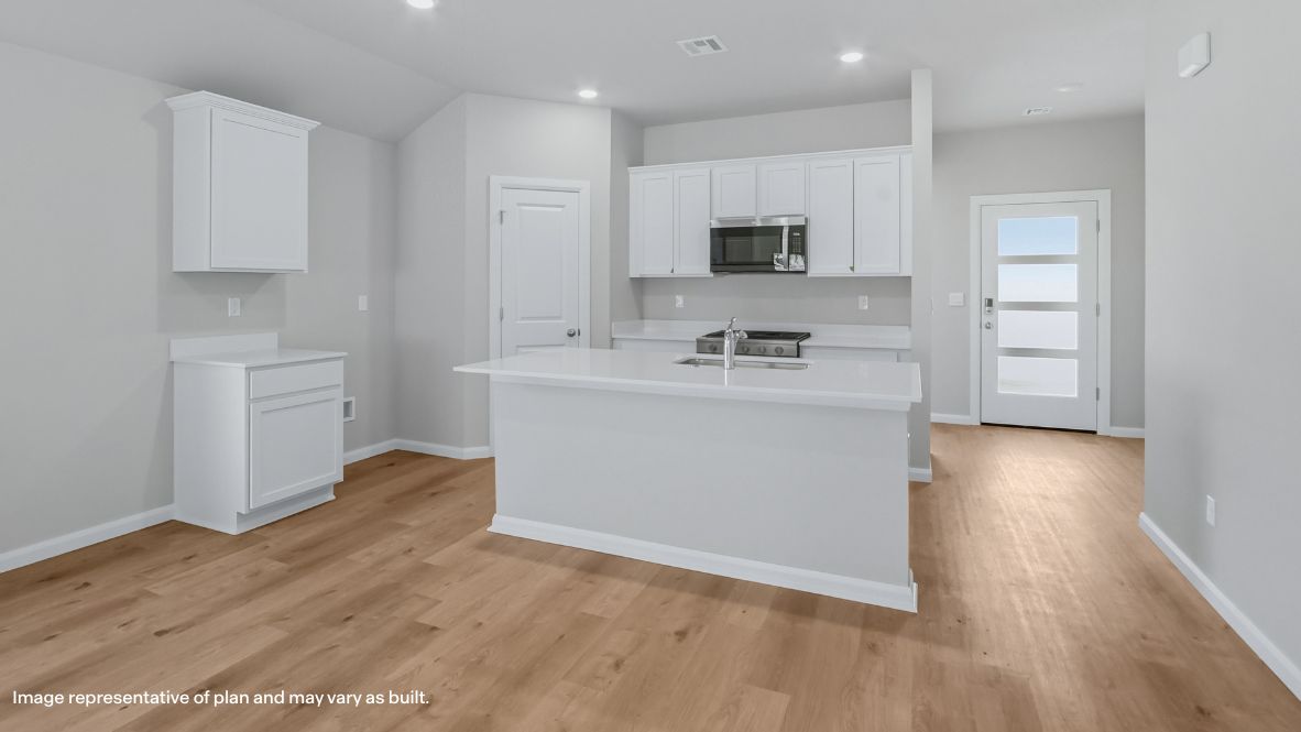 A well-organized living room that includes a kitchen and dining area, creating a warm and welcoming environment for gatherings.