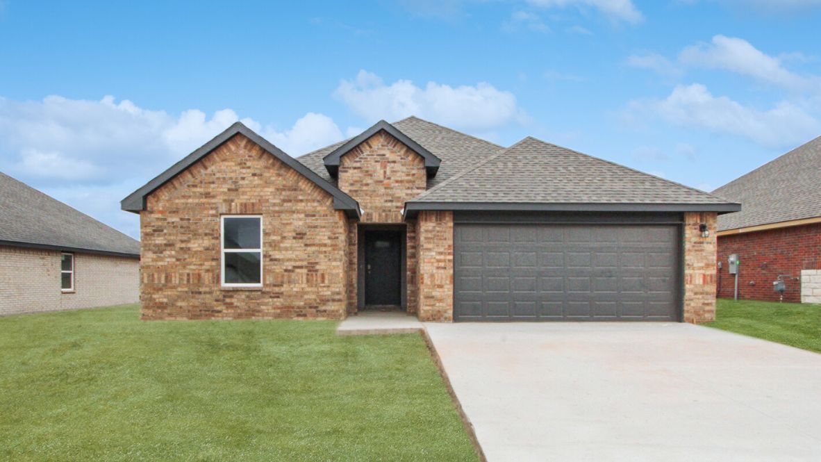 Front exterior in light blue showcasing entryway, windows, and landscaped yard Conrad Village