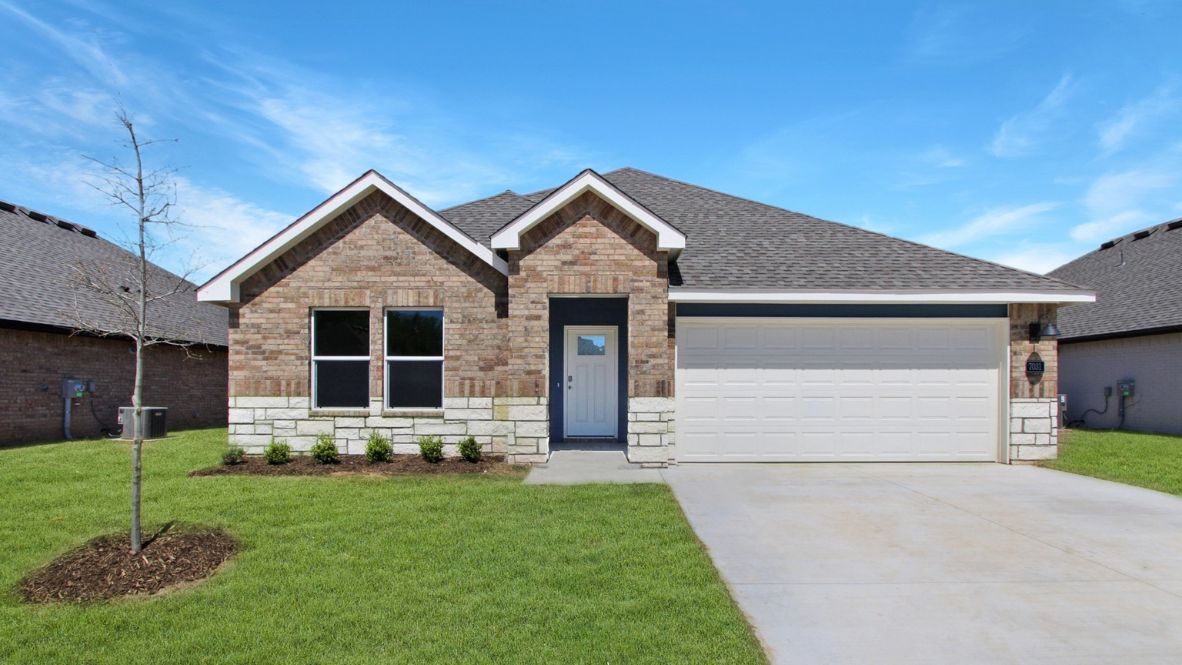 Front exterior in light white showcasing entryway, windows, and landscaped yard