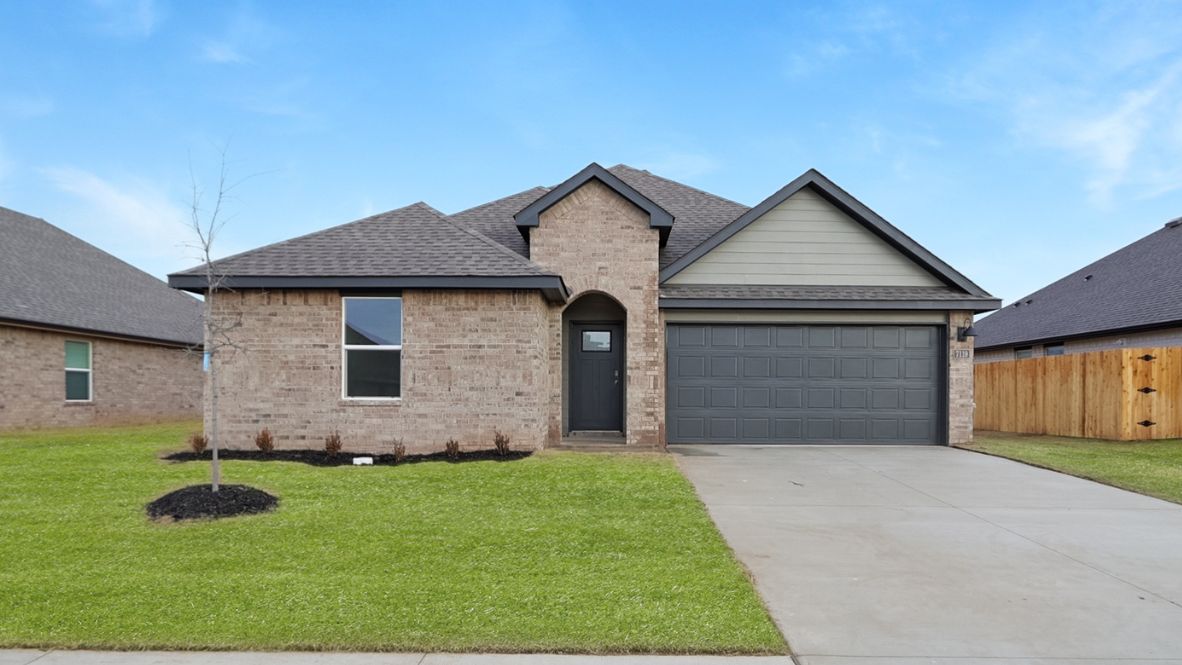 Conrad Village exterior from sidewalk view of grass and front of new house