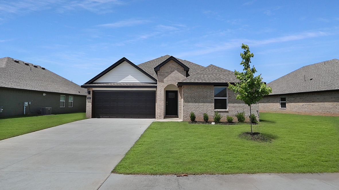 Conrad Village exterior from sidewalk view of grass and front of new house