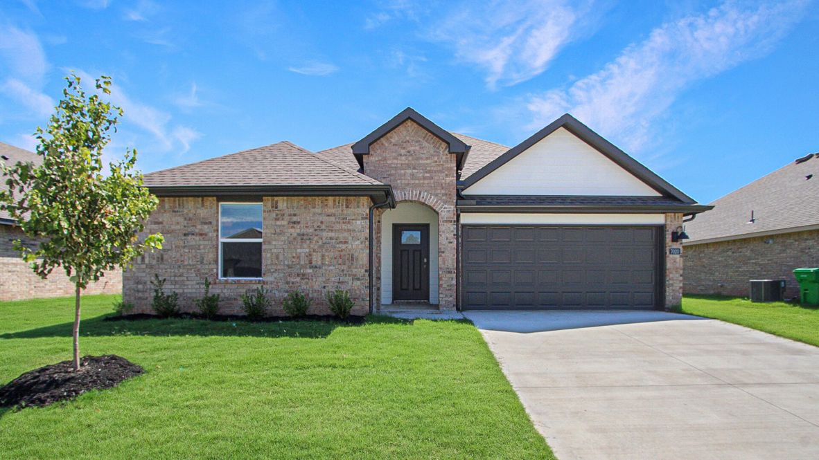 Conrad Village exterior from sidewalk view of grass and front of new house