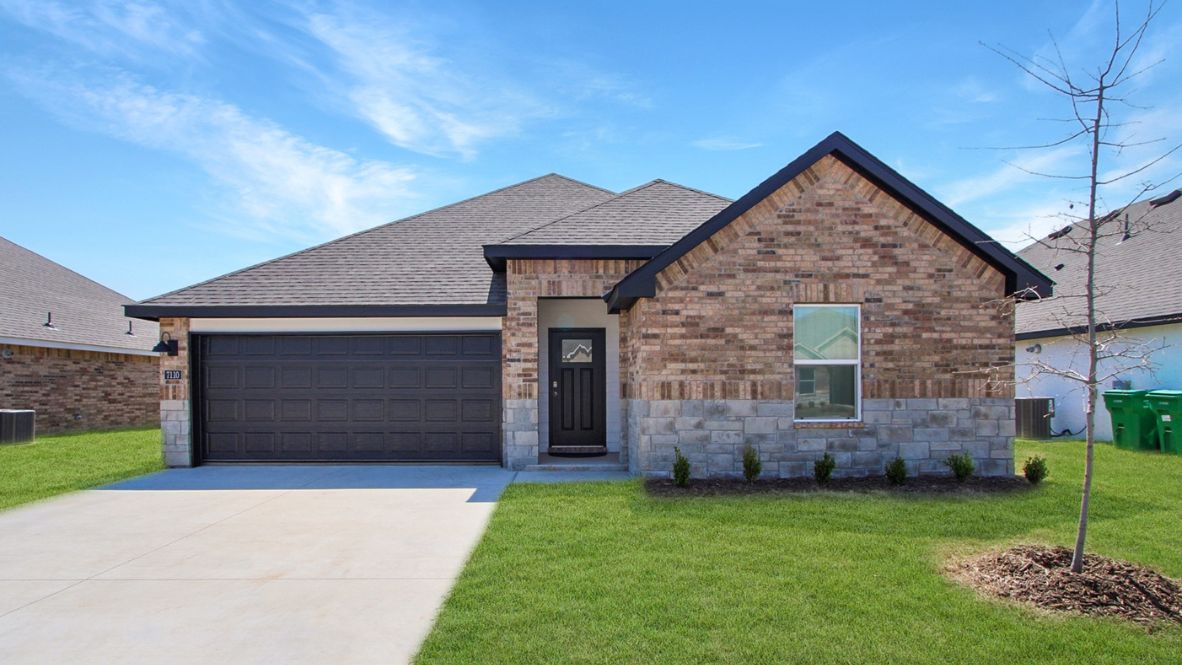 Front exterior Conrad Village  from sidewalk view of grass and front of new house