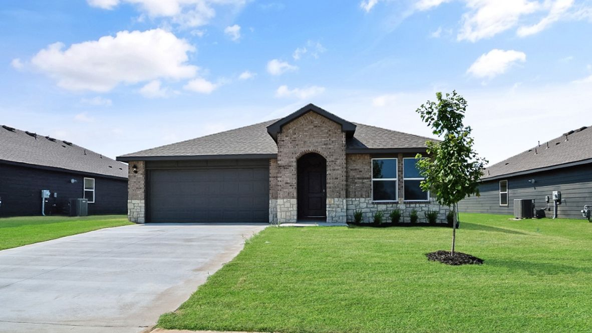 Sidewalk view featuring front façade, windows, and landscaped walkway