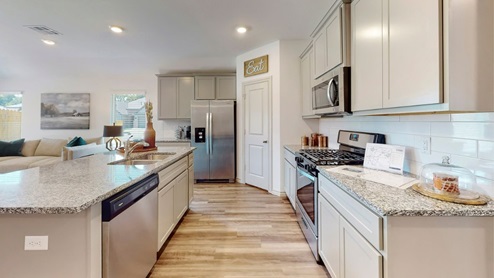 Open floor plan with luxury vinyl wood flooring granite counter tops and shaker cainets