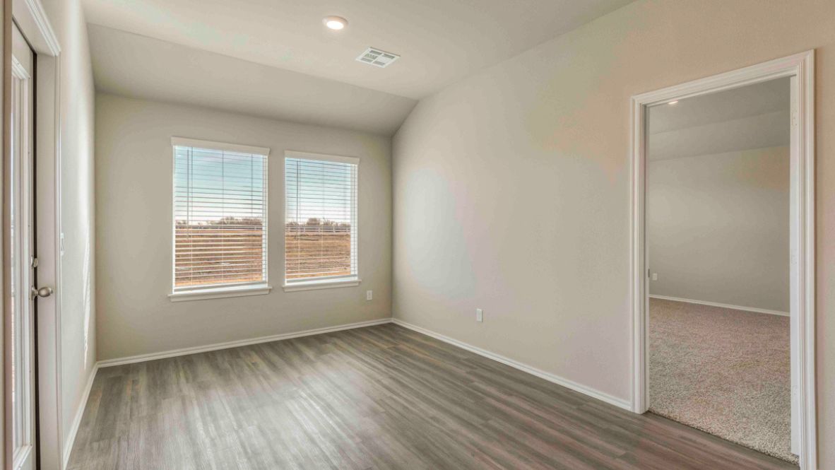 Bright and spacious kitchen with granite countertops, stainless steel appliances, and an island with bar seating