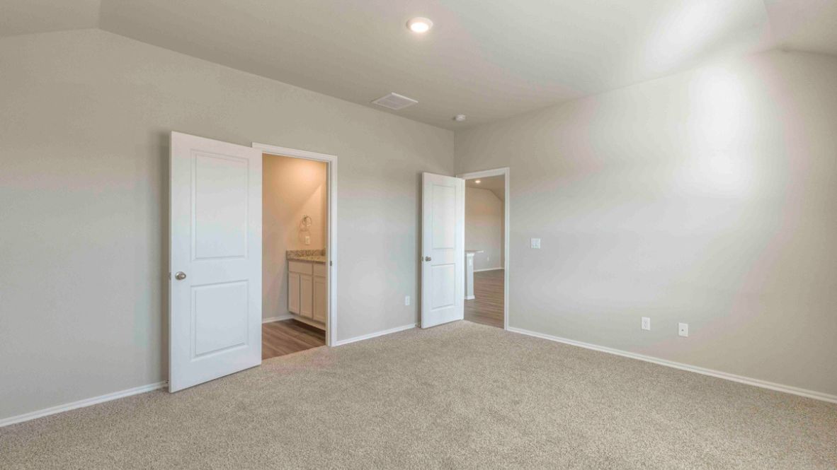 Open-concept living room featuring hardwood floors, large windows for natural light