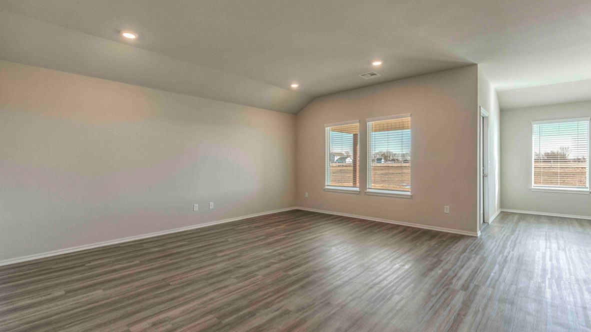 Bright and spacious kitchen with granite countertops, stainless steel appliances, and an island with bar seating