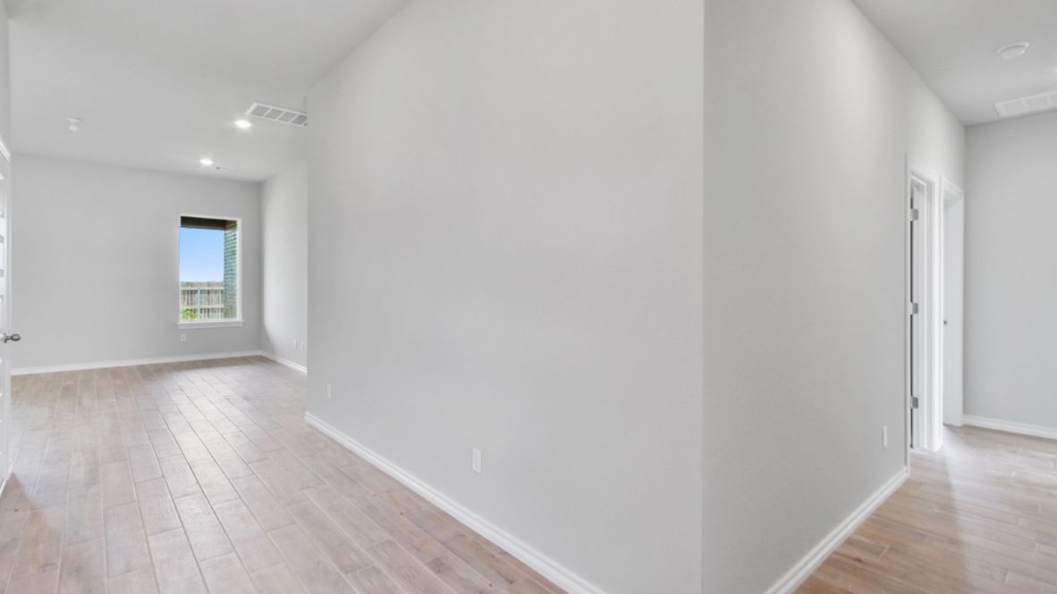 Entry hallway leading to living room and kitchen in the background.