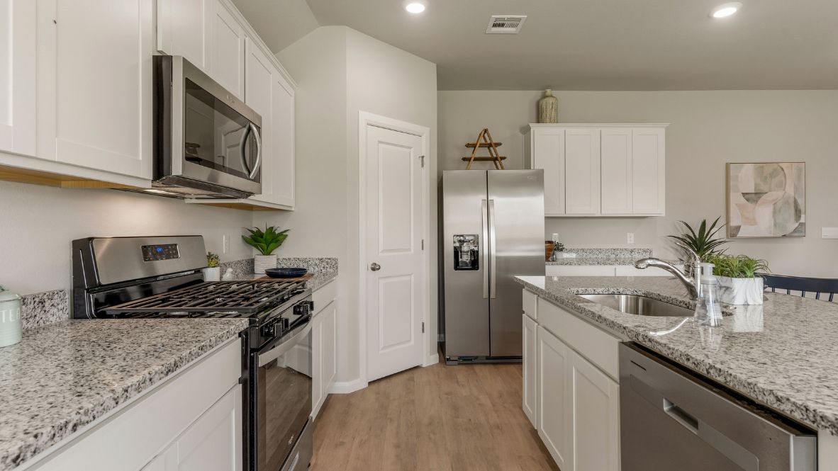 Welcome to Hawks Landing, where the Dean floor plan sets the standard for luxury and comfort in our prestigious new home community. From its grand brick and rock exterior to its professionally landscaped yard adorned with a mature tree in the front, this home boasts curb appeal that leaves a lasting impression.  Step inside to discover an inviting haven adorned with grand ceilings and an abundance of natural light that fills the space. The gourmet kitchen is a chef's dream, featuring white painted shaker style cabinets, granite countertops, and a generously-sized island perfect for hosting holiday gatherings or casual meals with loved ones. Indulge in luxury with luxury vinyl wood-look flooring throughout, offering both durability and timeless appeal. Retreat to the spa-like bathrooms, featuring a lavish walk-in shower with a full glass enclosure and 12x24 timeless marble tile surrounds in all showers.  Enjoy outdoor living to the fullest with a covered patio perfect for relaxing and entertaining. Plus, experience the convenience of smart home features and the sustainability of energy-efficient systems, ensuring your home is both technologically advanced and environmentally friendly.  Don't miss the opportunity to make the Dean floor plan your own. Contact us today and embark on the journey to your dream home in Hawks Landing.