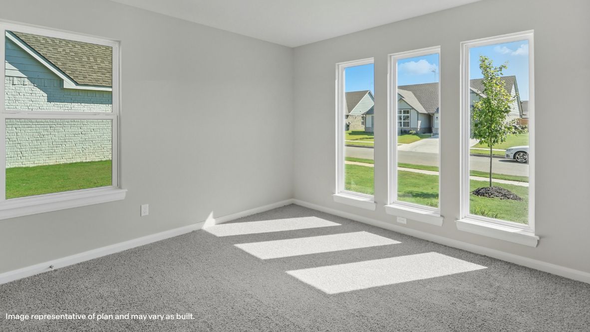 Comfortable guest bedroom featuring neutral-toned walls, carpeted flooring, and a large closet.